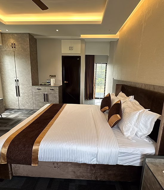 Luxury resort bedroom with king size bed, wardrobe, TV unit, and ambient ceiling lighting