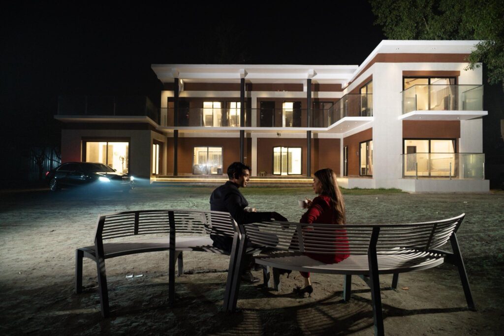 Couple enjoying night view at luxury resort villa in Gazipur
