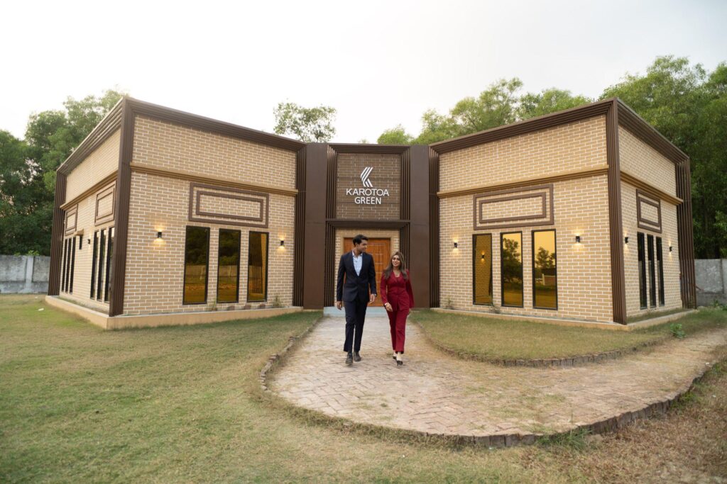 Karotoa Green resort exterior with couple walking in Gazipur