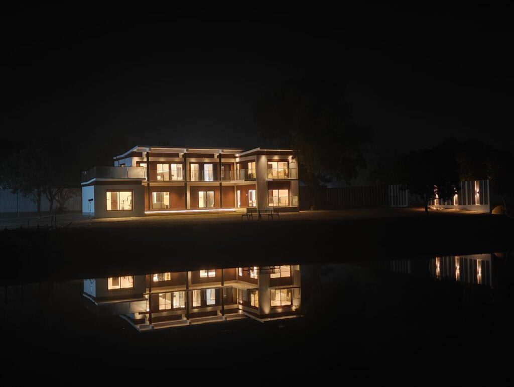 Luxury resort villa night view with reflection in water in Gazipur