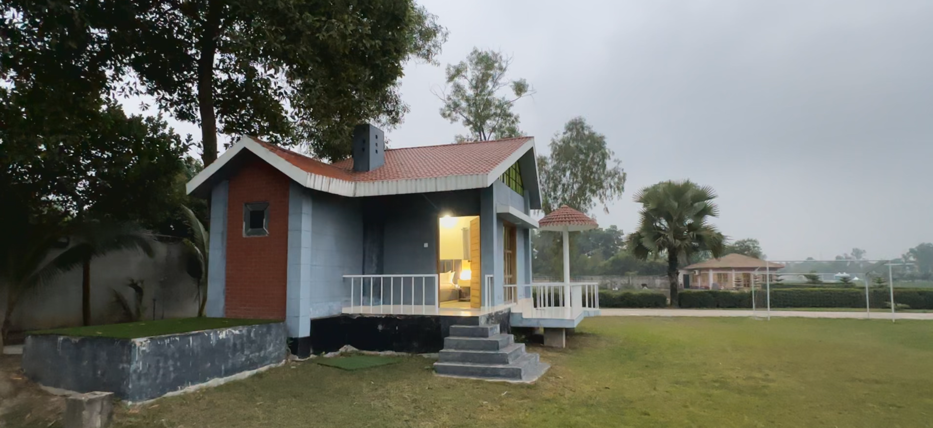 Private cottage at River Villa Resort Gazipur with open lawn and peaceful outdoor surroundings